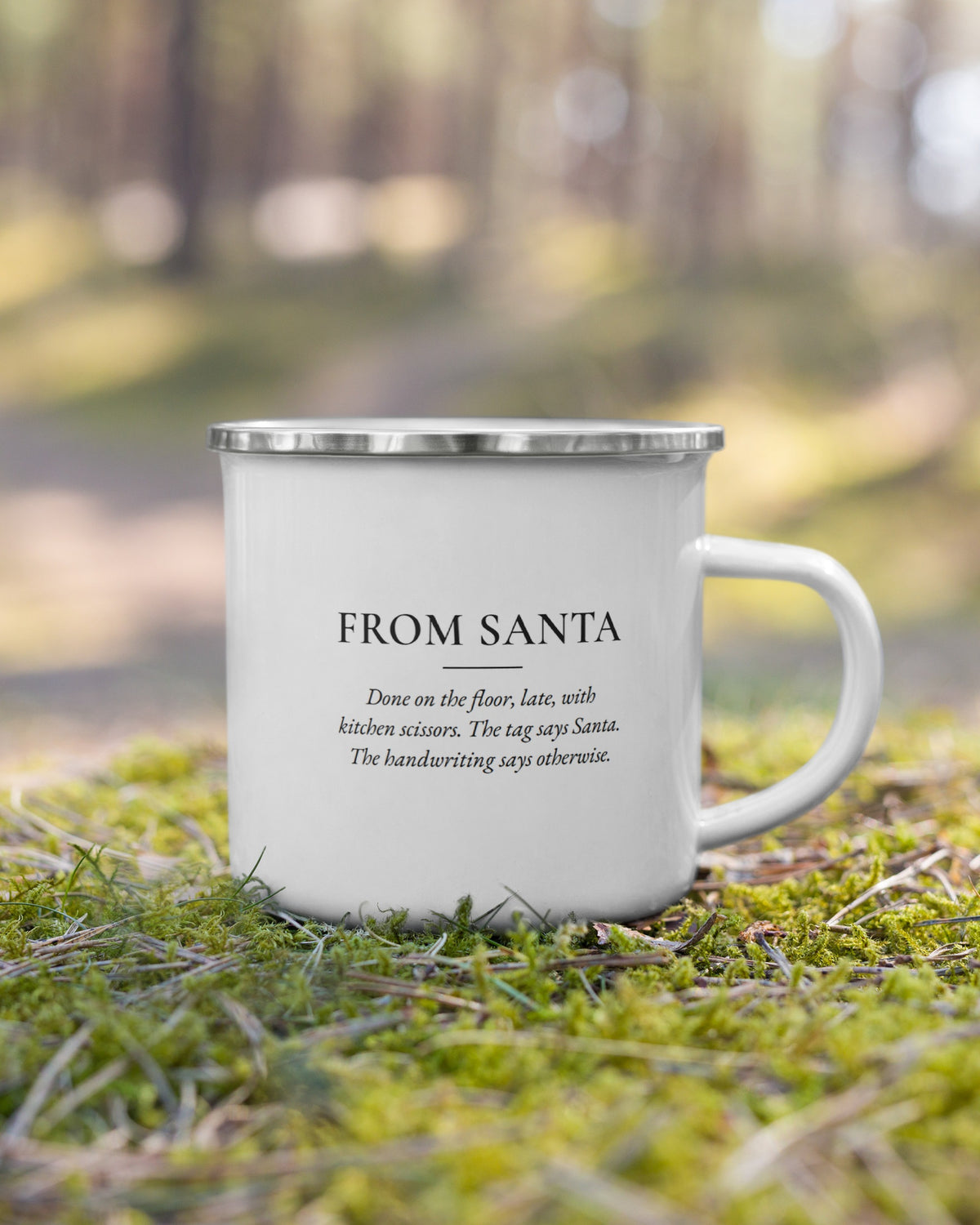 The From Santa enamel mug on moss in a forest