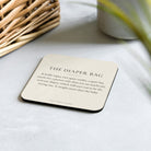 The Diaper Bag coaster from The Early Years on a kitchen counter
