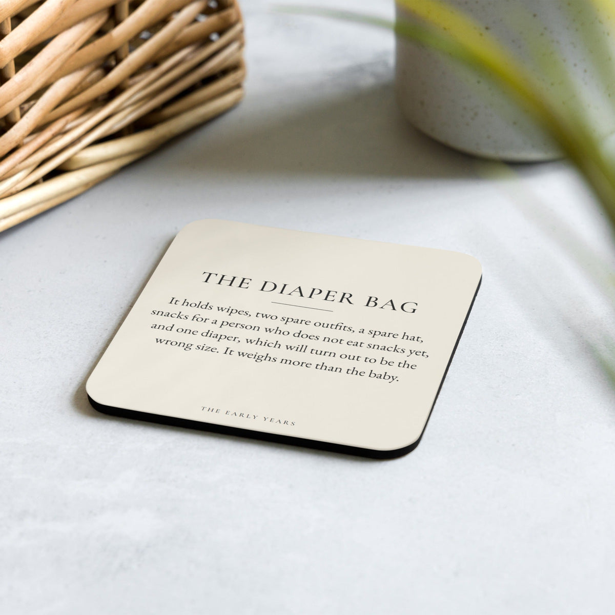 The Diaper Bag coaster from The Early Years on a kitchen counter