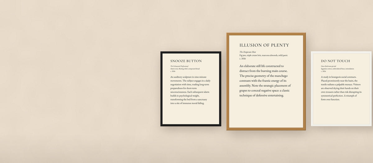 Three JestersBrush museum placard prints framed in black, white, and oak on a warm plaster wall
